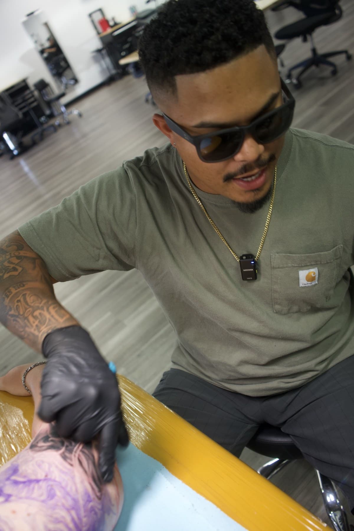 Close up of Roly holding a tattoo machine at Iconiq Tattoo Studio